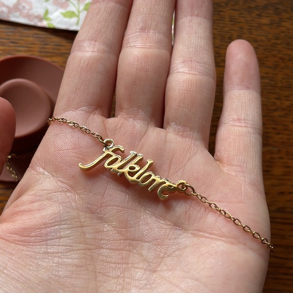 Claire's Jewelry - SOLD Taylor Swift Folklore Necklace  Album Gold Handwriting Script Text